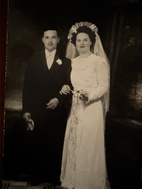 Black-and-white wedding portrait of Maurice and Denise, formally dressed, taken in the 1940s